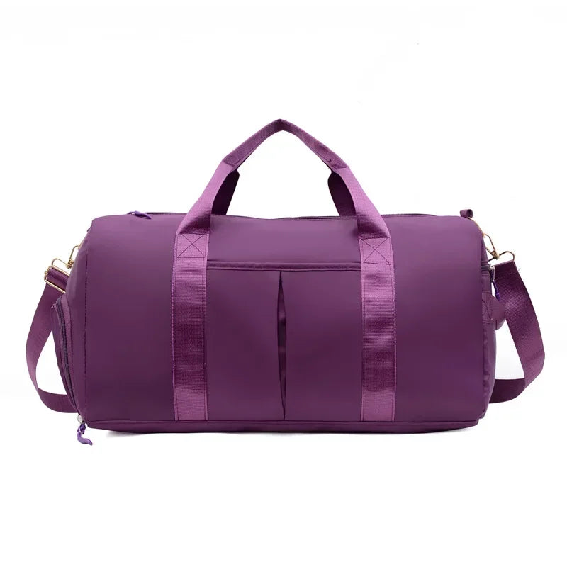 Purple duffel bag with handles and a shoulder strap on a white background