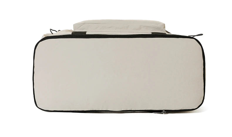 Beige travel bag with black zipper on a white background