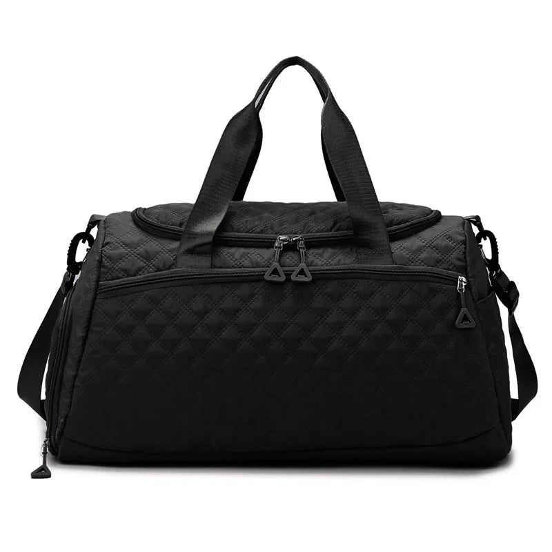 Black duffel bag with quilted pattern on a white background