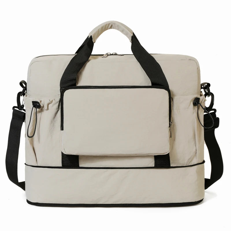 Beige travel bag with black straps on a white background