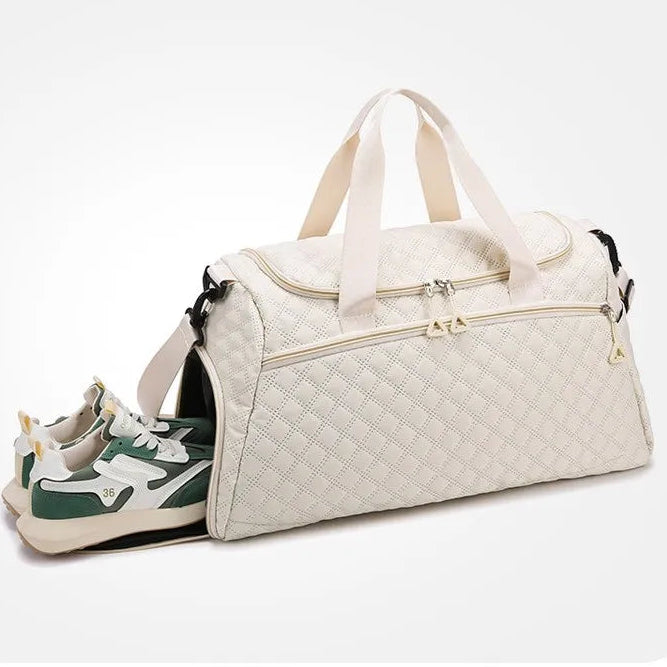 Beige travel bag with a side shoe compartment on a white background