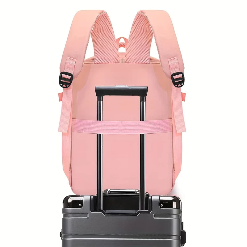 Pink backpack with rolling suitcase attachment on a white background