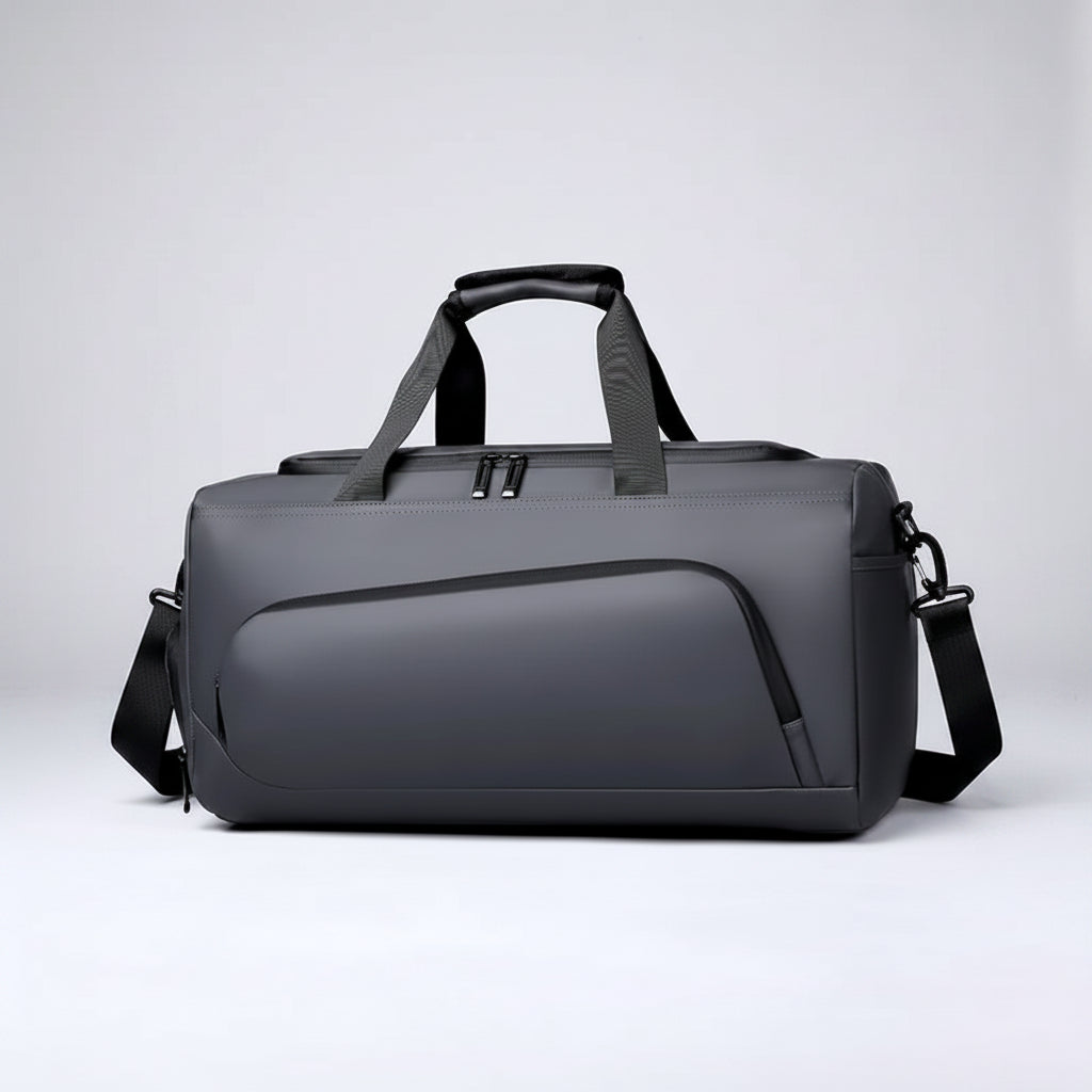 Gray duffel bag with black straps on a white background