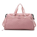 Pink quilted duffel bag on a white background