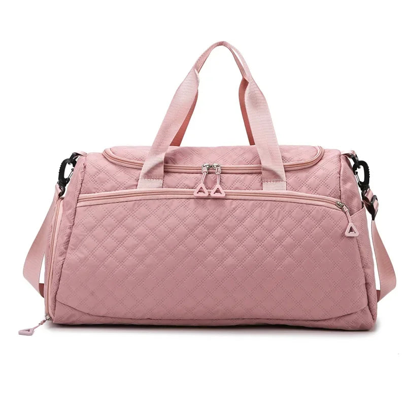 Pink quilted duffel bag on a white background