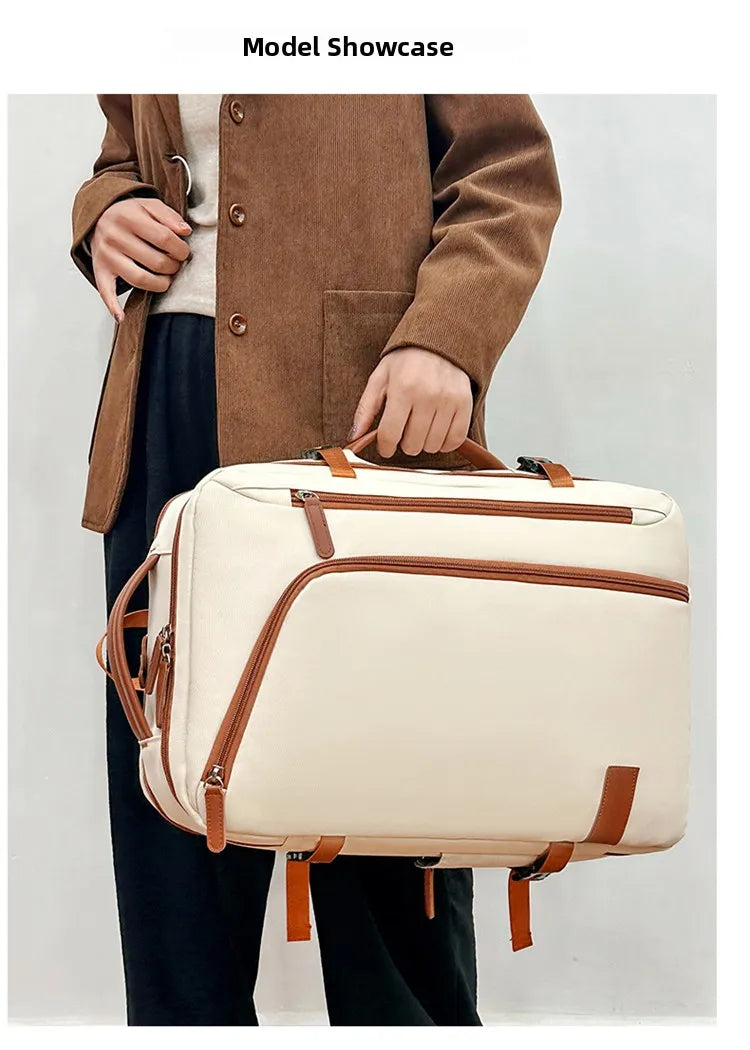 Person holding a beige suitcase with brown straps against a plain background