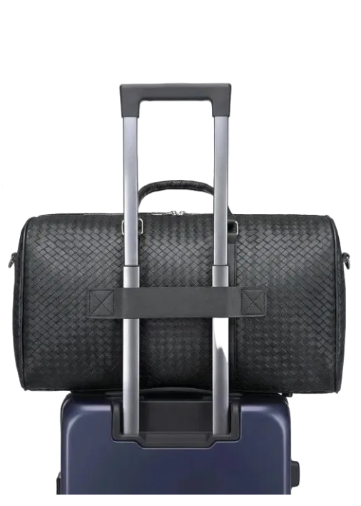 Black all-in-one storage bag with wheels attached to a suitcase on a light gray background.
