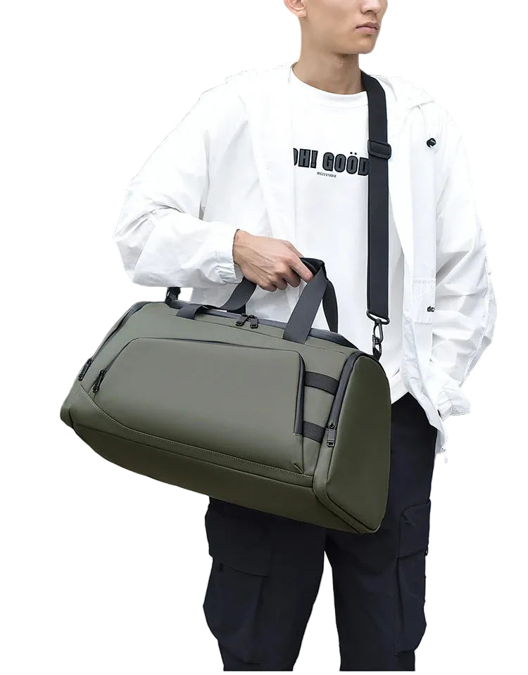 Person holding a green duffel bag with a blurred background