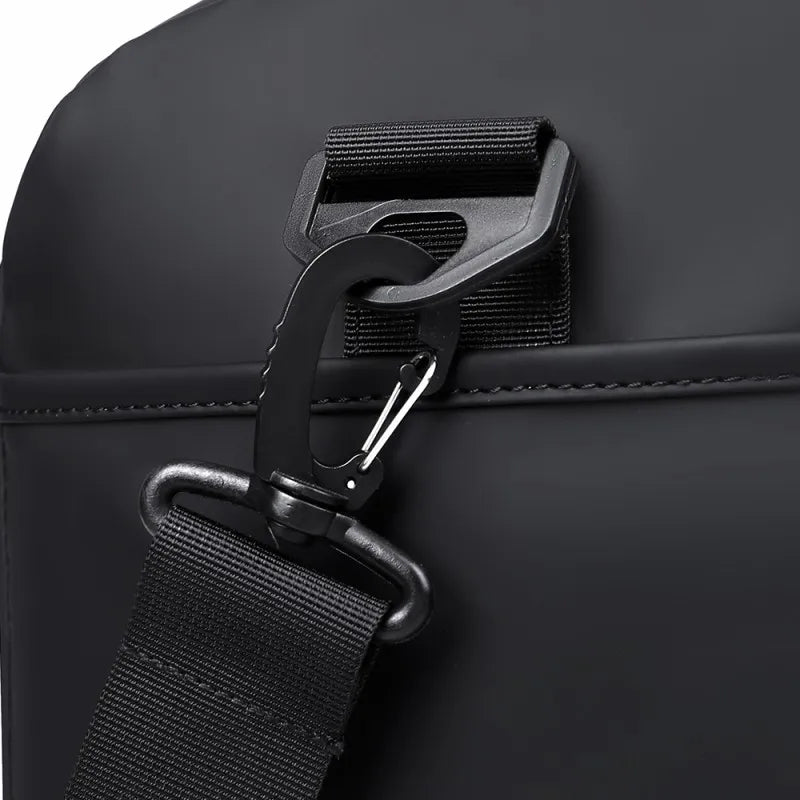 Close-up of a black bag with a strap and buckle on a white background
