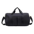Black duffel bag with gold zippers on a white background