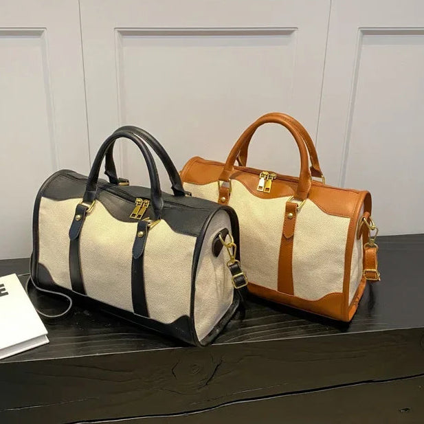 Two handbags, one black and one brown and white, on a dark surface with a magazine titled 'LIFE' in the background.