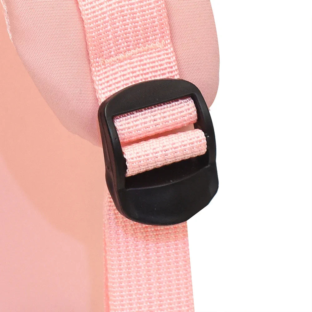 Close-up of a pink strap with a black buckle on a white background