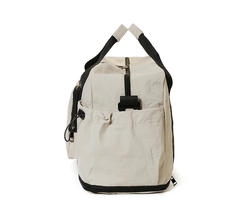 Beige backpack with black straps on a white background