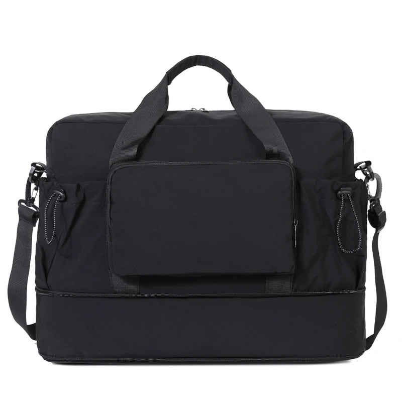 Black travel bag with multiple compartments and straps on a white background
