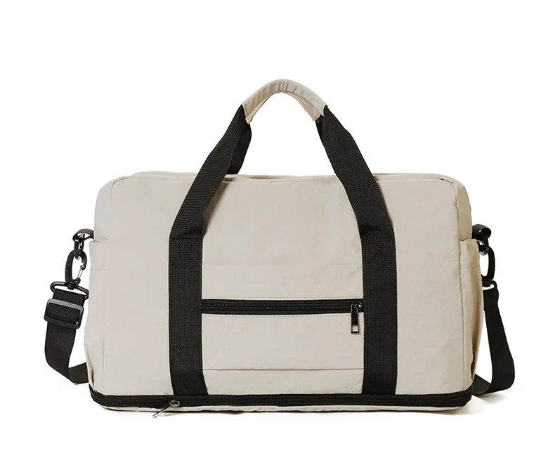 Beige duffel bag with black straps on a white background