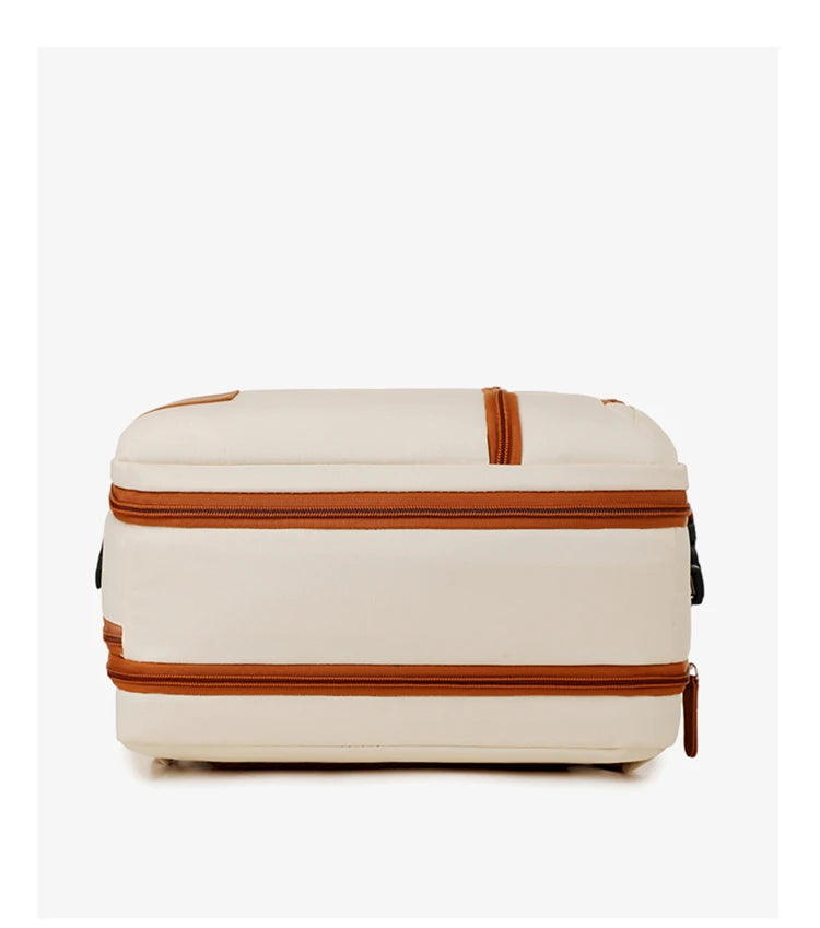 Beige suitcase with brown straps on a white background