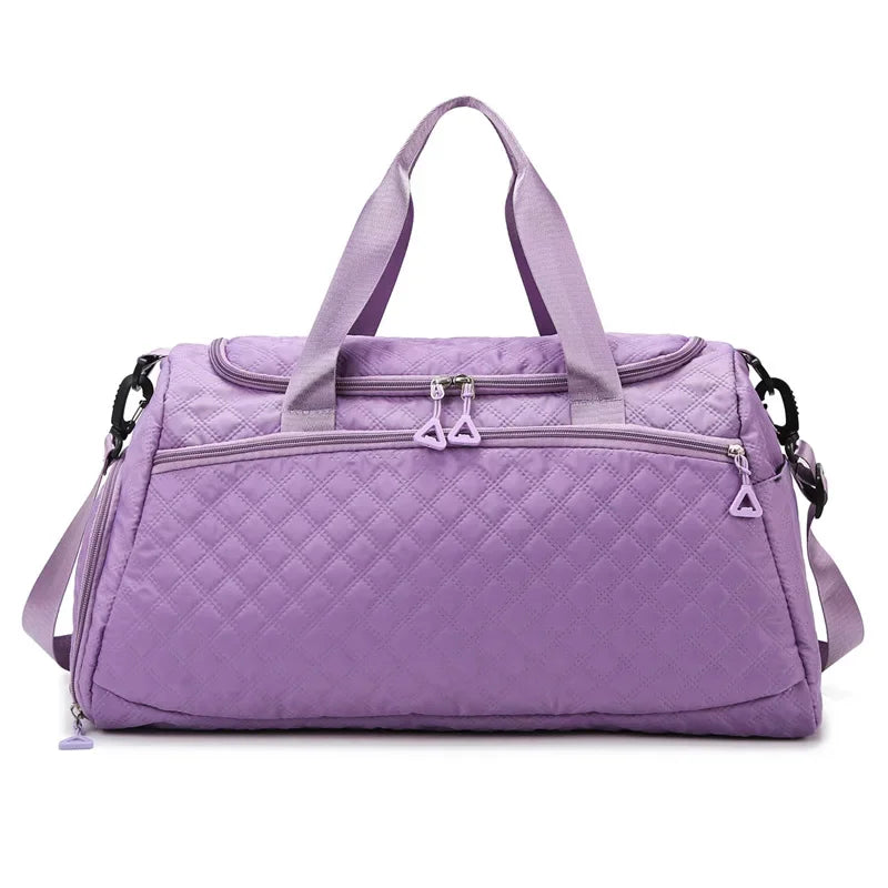 Purple quilted duffel bag on a white background