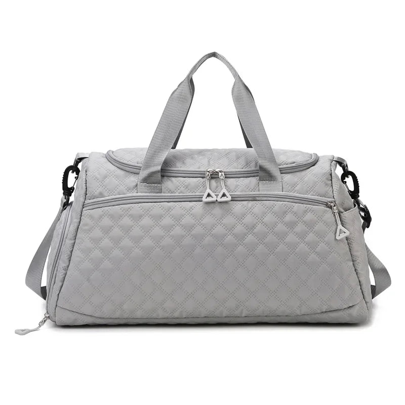 Gray quilted duffel bag on a white background